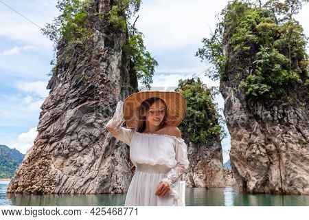 Happy Young Female Tourist In Dress And Hat At Longtail Boat Near Famous Three Rocks With Limestone 