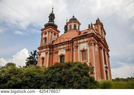 Valec, Western Bohemia, Czech Republic, 19 June 2021:  Baroque Red And Yellow Church Of The Holy Tri