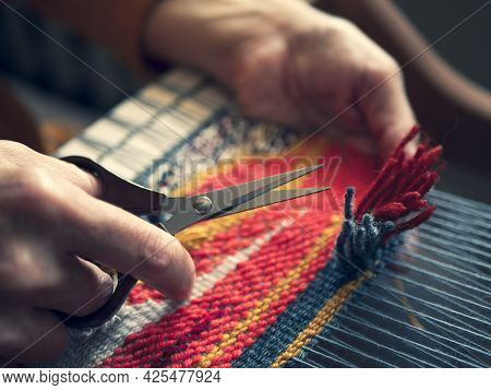 Master Weaver Is Cutting The Ends Of The Threads To Create A Cut Pile Carpet Effect. Making Coloured