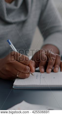 African American Student Writing High School Homework On Notebook Working Remote From Home. Black Wo
