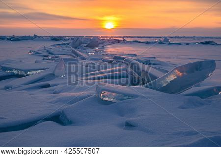 Beautiful Landscape Of Uzury Bay With Ice Hummock Rising Above The Frozen Lake Of Baikal At Sunrise.