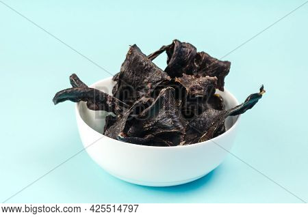 Training Treats For Pets On Blue Background. Natural Air Dried Dog Treats In A White Ceramic Bowl. T