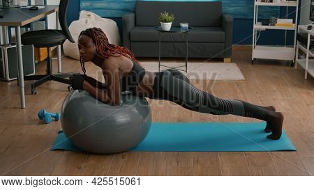 Athletic Fit Woman Working Abdominal Muscle While Sitting On Yoga Swiss Ball During Morning Workout 