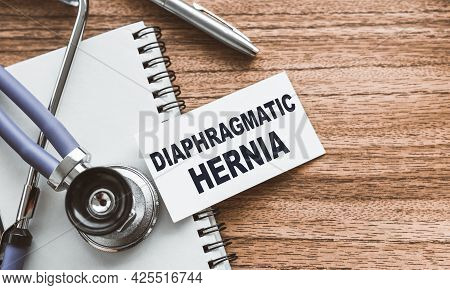 A Card With Text Diaphragmatic Hernia On Wooden Doctor's Table