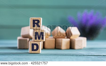 Rmd (required Minimum Distribution) - Acronym On Wooden Cubes On A Green Background With Lavender. B