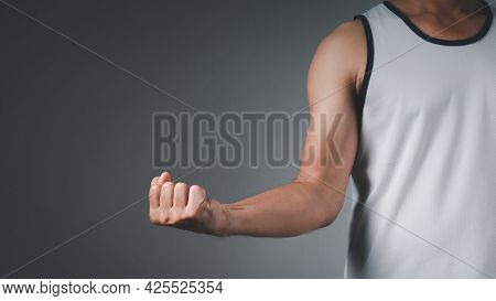 The Man Wearing Sports Clothes Stretching After Working Out.