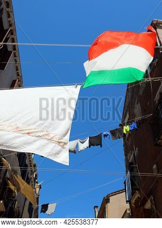 Many Clothes Hanging Out Drying In The Sun In The Narrow Street Of The Typical Mediterranean City Wi