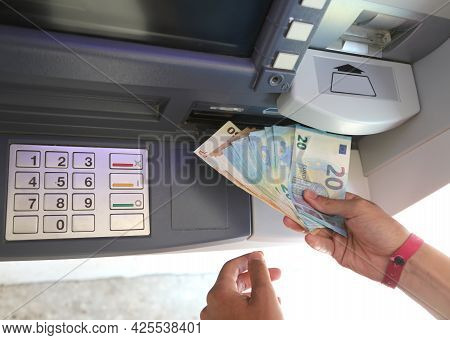 Euro Banknotes Just Withdrawn From The Atm And The Hand Picking Them Up With The Numeric Keypad Afte