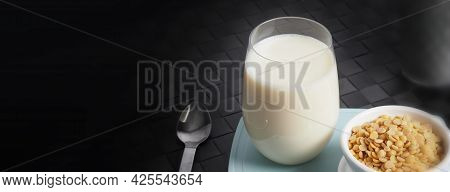 Soy Milk With No Sugar Added In A Glass On A Green Color Plastic Plate Mat.