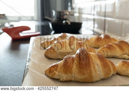 Croissant Baked Fresh On Board With Baking Paper For Homemade Breakfast
