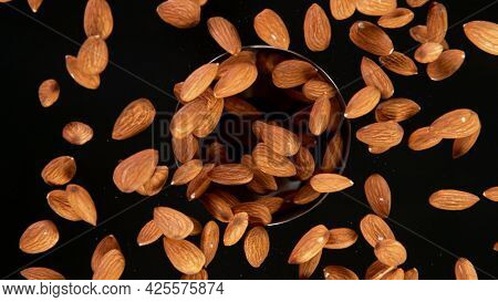 Rotating Raw Almonds on Black Background. Top Shot.