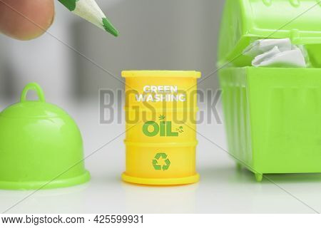 Greenwashing Concept. Oil Barrel With Recycle Symbol And Green Text. Greenwashing Is A Communication