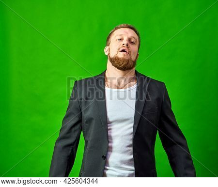Hustler Man In A Black Jacket Looks At The Camera With A Very Important Look. The Emotion Of A Leade