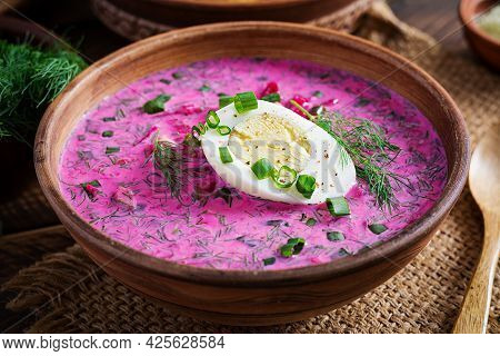 Cold Borscht, Summer Beet Soup With Fresh Cucumber,  Boiled Egg And Baked Potatoes On Wooden Table. 