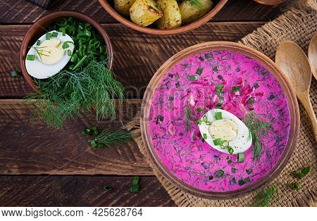 Cold Borscht, Summer Beet Soup With Fresh Cucumber,  Boiled Egg And Baked Potatoes On Wooden Table. 