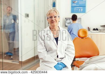 Stomatological Doctor Looking Into Camera While Waiting For Pacient Examination In Hospital Dental R