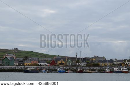 Colorful Houses Lining The Harbor Of Dingle Ireland.