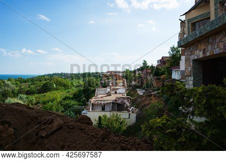 A Landslide Caused By Hurricane Rains Destroyed Expensive Cottages And Houses. A Destroyed House, A 