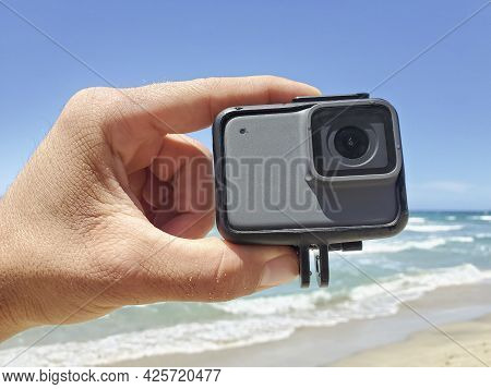 Man Hand While Holding Action Water Resistent Camera Before Filming Sport Session, Tech Devices
