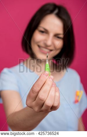 Beautiful Happy Young Woman Using Interdental Brush On The Pink Background