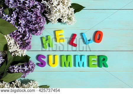 On A Wooden Background There Is An Inscription In Multicolored Letters Hello Summer Surrounded By Li