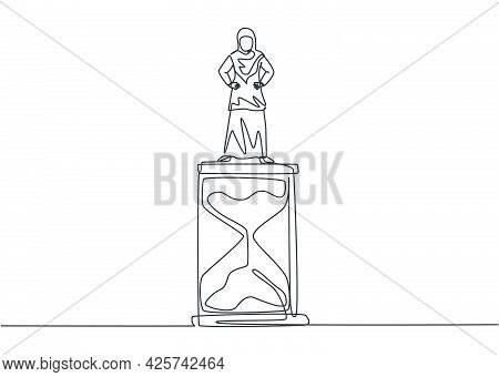 Single One Line Drawing Of Young Arabian Business Woman Standing Above Hourglass. Symbol To Show Tim