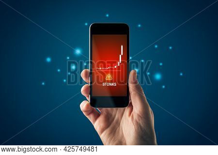 Stonks (meme Stock) Investment Warning Concept With Smart Phone. Soaring Graph Of Stock Or Cryptocur
