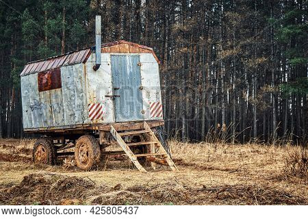 Semi Trailer House With Chimney And Steps Near Pine Trees