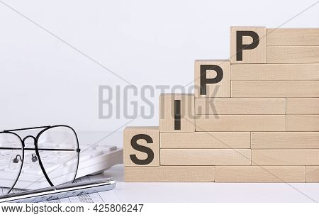 Wooden Cubes With Letters Sipp On White Table With Keyboard And Glasses