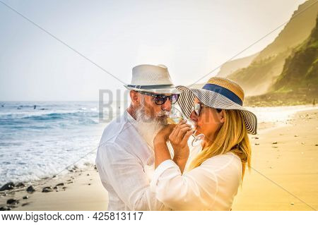 Lifestyle Of Caucasian Senior Couple Drinking Champagne On Beach, Happy In Love Romantic And Relax T