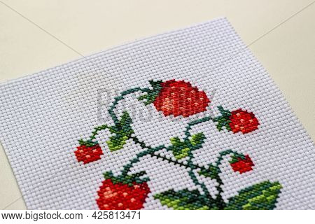 Red Ripe Strawberries Embroidered With A Cross-stich On A White Canvas By Hand. Close Up, Macro.