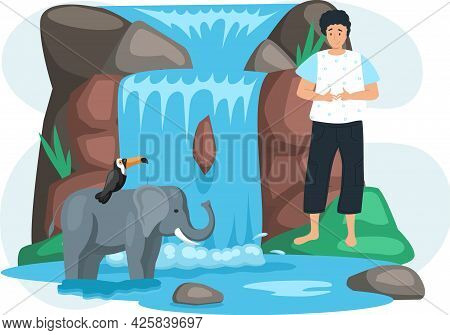Guy Looks At Animals Near Waterfall In Green Forest. Toucan Sits On Elephant On Its Back In Beautifu