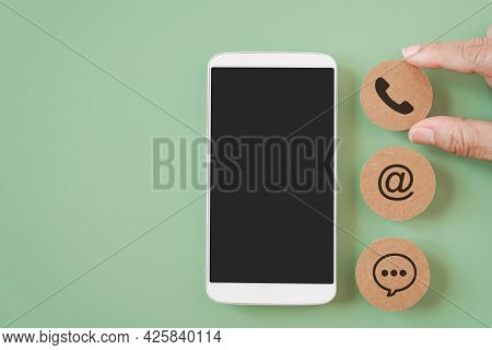 Hand Choose Call Sign And White Mobile Phone With Clipping Path On Touchscreen And Blurred Brown Con