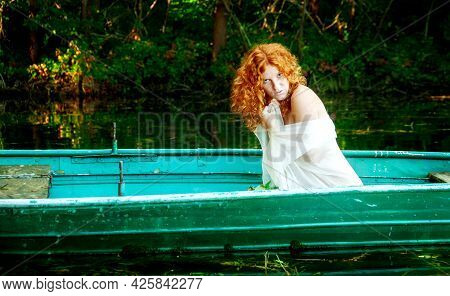 Sensual, Seductive, Young Sexy Red-haired Woman With White Dress In A Boat Like A Redhead Siren In A