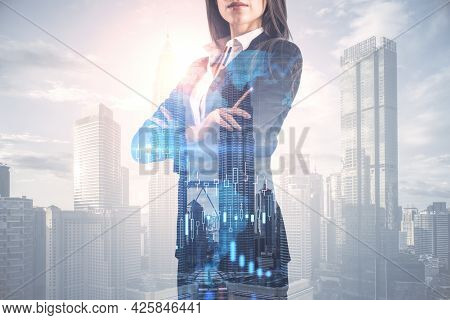 Pretty Young European Businesswoman With Folded Arms Standing On Abstract Bright City Background Wit