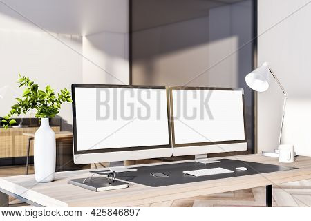 Modern Office Interior With Desktop, Empty White Computer Monitors And Other Items. Mock Up, 3d Rend