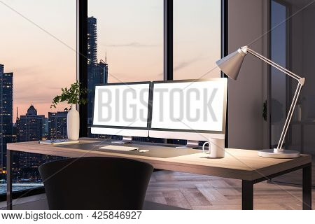Two Blank White Computer Screens On Office Desktop In Interior With Night City View. Corporate Templ