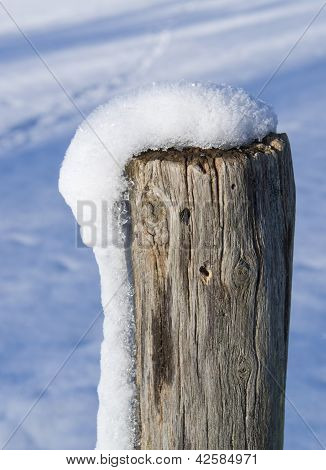 Snowy Wooden Pole