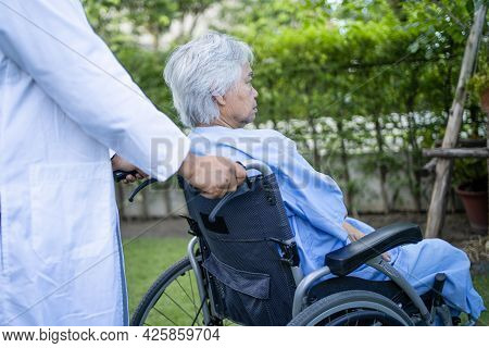 Doctor Help And Care Asian Senior Or Elderly Old Lady Woman Patient Sitting On Wheelchair At Park In