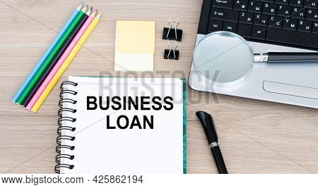 Business Concept - Top View Notebook Writing Business Loan