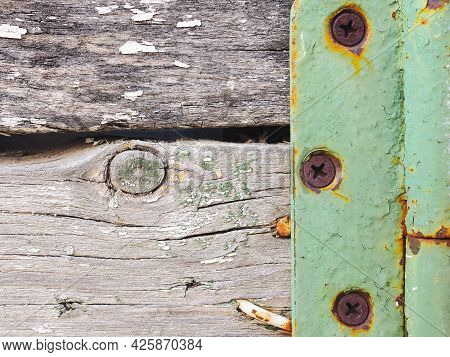 Fragment Of A Rustic Gate In A Fence Close-up. Old Gray Weathered Wooden Beams And Door Hinge. Vinta