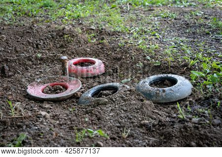 Some Quoits Resting In The Hole Around The Peg.