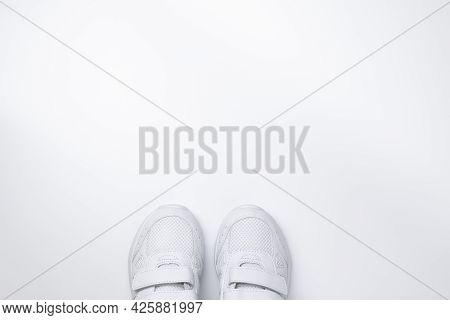 Flat Lay Two White Sneakers Partially Located At The Bottom In The Center With Free Space For Text I