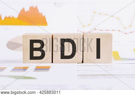 On A Light Background, Graphs, Diagrams And Wooden Cubes With The Word Bdi - Brand Development Index