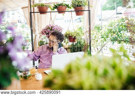 Disabled Man With Wheelchair In Restaurant Eating