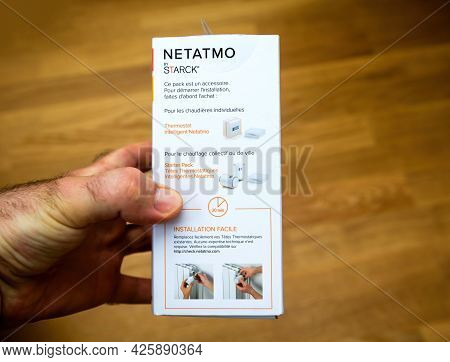 Paris, France - Apr 21, 2021: Pov Male Hand Holding - Netatmo By Starck Thermostatic Radiator Intern
