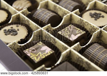 Chocolate Candies Set In An Open Box. Chocolate Candy Closeup. Assorted Chocolate Sweets.