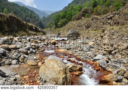 Himalayan Rivulet , A White Vehicle Crossing The River.