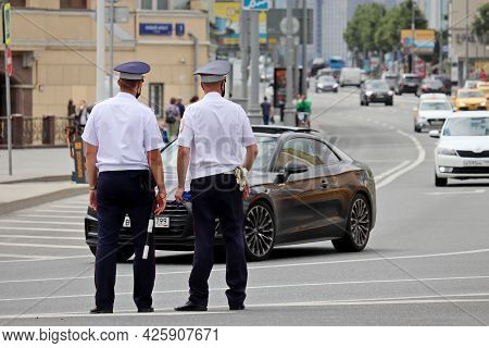 Moscow, Russia - July 2021: Two Traffic Police Officers In Masks Standing On The Road. Policemen On 