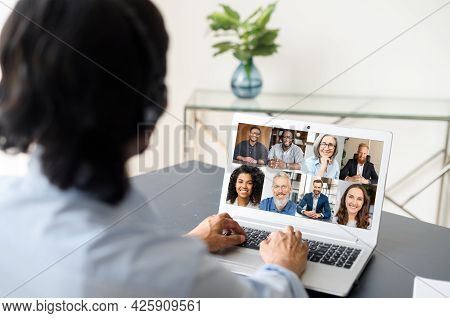Male Employee Involved Video Meeting On The Laptop With Diverse Workteam, Indian Man Using Computer 
